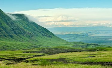 A sweeping view of the Rift Valley, showcasing its dramatic, expansive landscape with rolling hills and distant escarpments.
