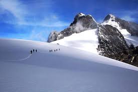 Snow-capped peaks of the Rwenzori Mountains, contrasting against a clear sky.